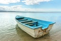 Empty old wooden boat on shallow water Royalty Free Stock Photo