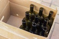 Empty olive-colored wine bottles packed in a box and prepared for bottling Royalty Free Stock Photo