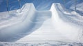 Pristine Olympic halfpipe covered in fresh snow, prepared for snowboarding and freestyle skiing events in a winter mountain resort Royalty Free Stock Photo