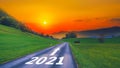 Empty open asphalt road and New year 2021 concept. Driving on empty road goals against sun in mountains to upcoming 2021 and Royalty Free Stock Photo