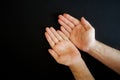 Empty open calloused male palms on black background. Trust and frugality. Palmistry and predestination of fate. Close-up