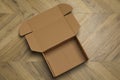 Empty open cardboard box on floor, top view Royalty Free Stock Photo