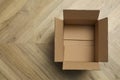 Empty open cardboard box on floor, top view. Space for text Royalty Free Stock Photo