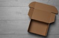 Empty open cardboard box on floor, top view. Space for text Royalty Free Stock Photo