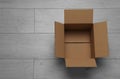 Empty open cardboard box on floor, top view. Space for text Royalty Free Stock Photo