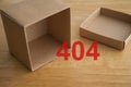Empty open paper box with 404 error code on wooden table. Royalty Free Stock Photo