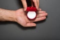 Empty open red jewelry box in a male hands. Present. Black background. Top view Royalty Free Stock Photo