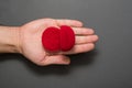 Empty open red jewelry box in male palm. Present. Black background. Top view Royalty Free Stock Photo