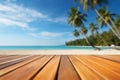 Empty orange bamboo table top stands for display product against the defocused white sand beach surrounded with coconut trees and Royalty Free Stock Photo