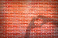 Empty orange brick wall background texture with hands making love heart shadow.