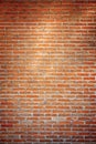 Empty orange brick wall background texture with spot light in the middle. Royalty Free Stock Photo