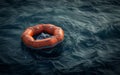 An empty orange inflatable life raft adrift on the ocean waves, symbolizing isolation and danger. Royalty Free Stock Photo