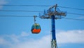 Orange telegondola near a cable post