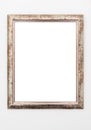 Empty ornate picture frame hanging on wall