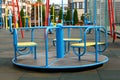 Empty outdoor children`s playground with merry-go-round in residential area Royalty Free Stock Photo