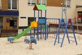 Empty outdoor children`s playground in residential area Royalty Free Stock Photo