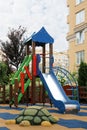 Empty outdoor children`s playground with slide in residential area Royalty Free Stock Photo