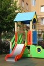 Empty outdoor children`s playground with slide in residential area Royalty Free Stock Photo