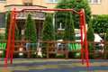 Empty children`s playground with swings in residential area Royalty Free Stock Photo