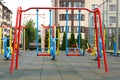 Empty outdoor children`s playground with swings in residential area Royalty Free Stock Photo