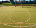Empty outdoor handball playground, plastic hairy green surface on ground and white blue bounds lines. Royalty Free Stock Photo