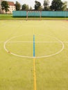 Empty outdoor handball playground, plastic light green surface on ground. Empty gate. Royalty Free Stock Photo