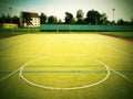 Empty outdoor handball playground, plastic light green surface on ground and white blue bounds lines. Royalty Free Stock Photo