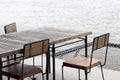 Empty outdoor old vintage wood table and chair in coffee shop restaurant near river Royalty Free Stock Photo