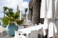 Empty outdoor restaurant, dining place or cafe with tables and chairs set on a deck next to the beach Royalty Free Stock Photo