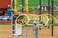 An empty outdoor sports ground with outdoor exercise equipment and modern rubber coating. Metal vandal-proof sports equipment in