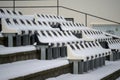 Empty outdoor stadium seats covered with snow in winter Royalty Free Stock Photo