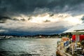 Empty outdoor summer cafe tables and chairs near the sea after a Royalty Free Stock Photo