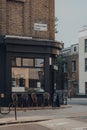 Empty outdoor tables of Guy Gold coffee shop in Camden, London, UK