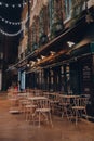 Empty outdoor tables of a restaurant inside Neal`s Yard in Covent Garden, London, UK Royalty Free Stock Photo