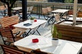 Empty outdoor tables of waterfront restaurant