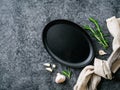 Empty oval cast iron frying pan on dark grey concrete background Royalty Free Stock Photo