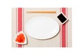 Empty oval white plate with chopsticks for sushi and soy sauce, ginger on sushi mat background. Top view with copy space for you Royalty Free Stock Photo
