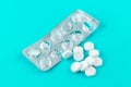 Empty pack with white pills packed in blister with copy space on turquoise background. Focus on foreground, soft bokeh. Pharmacy d Royalty Free Stock Photo