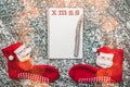 Empty page of spiral notebook and Christmas red stockings on a snow background Royalty Free Stock Photo