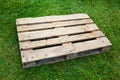 Empty pallet on green grass Royalty Free Stock Photo