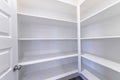 Empty pantry of house with built in shelves for storage and organization of food
