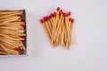 Empty paper matchbox with wooden matches on it