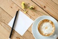 Empty paper note and a cup of cappuccino coffee Royalty Free Stock Photo