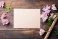 empty paper note with pink flowers on wooden background Royalty Free Stock Photo