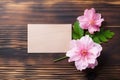 empty paper note with pink flowers on wooden background Royalty Free Stock Photo