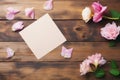 empty paper note with pink flowers on wooden background Royalty Free Stock Photo