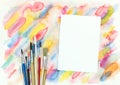 Empty paper with paintbrushes over colorful diagonal watercolor