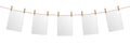 Empty paper sheet hanging on rope, isolated on white background Royalty Free Stock Photo