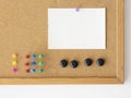 Empty paper sheet mockup for notes. Cork board background with colorful pins Royalty Free Stock Photo