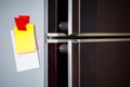 Empty paper sheet on refrigerator door with magnetic clip paper note for add text message Royalty Free Stock Photo